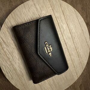 Coach Black, tan and gold hardware envelope style card case